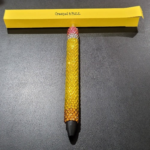 A pen that looks like a pencil made with glass rhinestones. Great for a teachers gift. The ink is refillable. Handmade