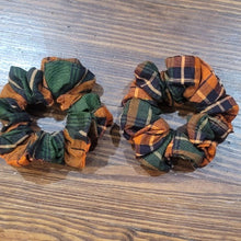 Load image into Gallery viewer, Handmade orange shimmer hair scrunchie. A comfortable way to keep your hair up and it even looks cute on your wrist when you want to take your hair down.  
