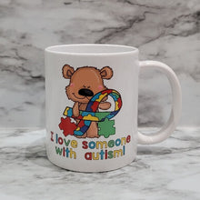 Load image into Gallery viewer, This vibrant, durable, and long lasting Autism Love mug will stand out. Drink your favorite coffee or tea with a mug that shows off your style and personality. Make your Autism Love mug extra special by adding a name.
