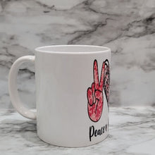 Load image into Gallery viewer, This vibrant, durable, and long lasting Breast Cancer Peace, Love, Cure mug will stand out. Drink your favorite coffee or tea with a mug that shows off your style and personality. Make your Peace, Love, Cure mug extra special by adding a name.
