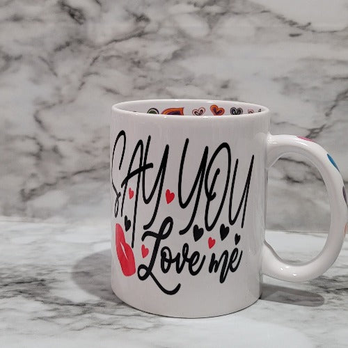 This Say You Love Me vibrant, durable, and long lasting mug will stand out with the special messages inside. Drink your favorite coffee or tea with a mug that shows off your style and personality. Make your Say You Love Me mug extra special by adding a name.  Great gift for the one you love. You can put hot and cold drinks in them. 